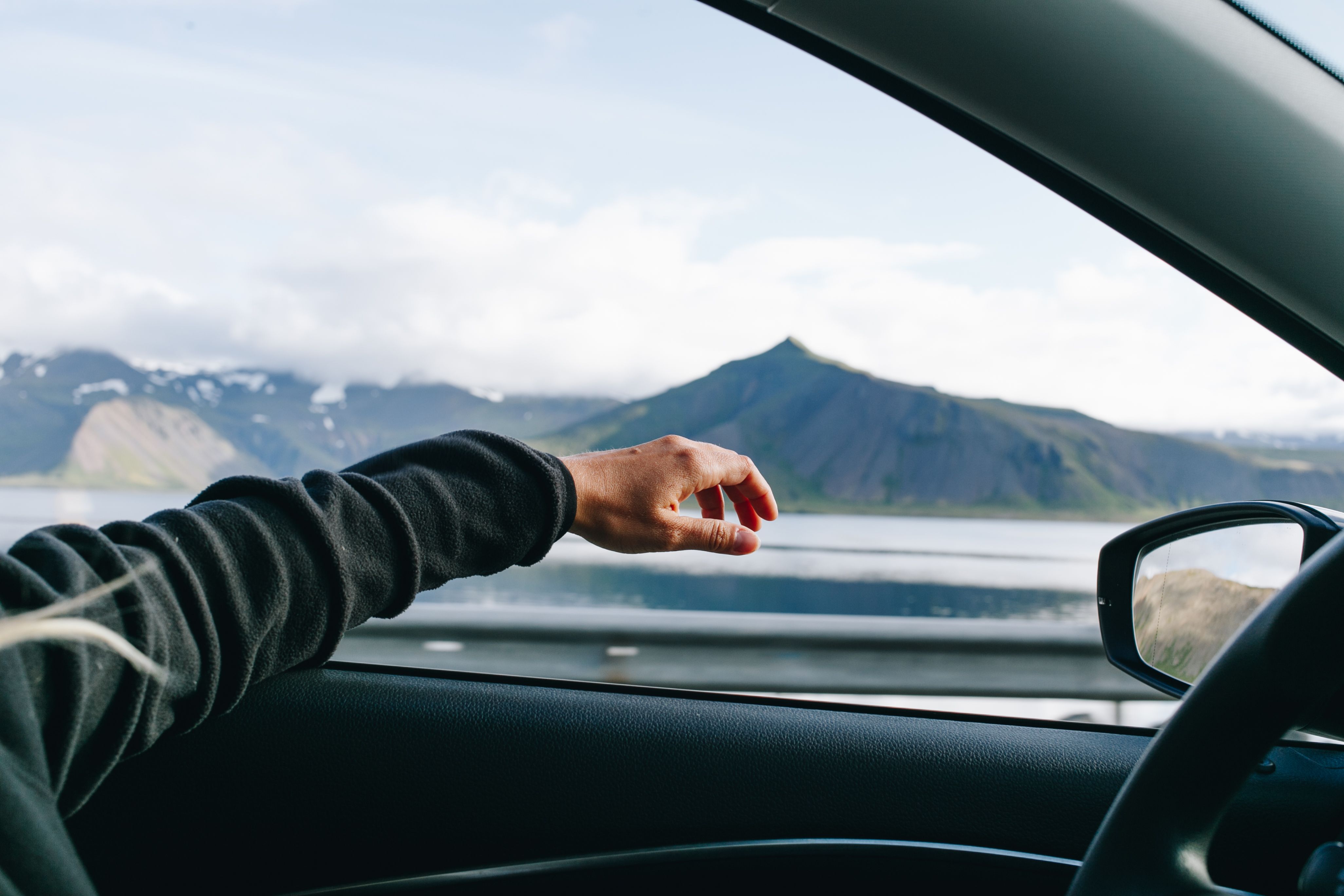 man-hold-out-hand-when-driving-car.jpg
